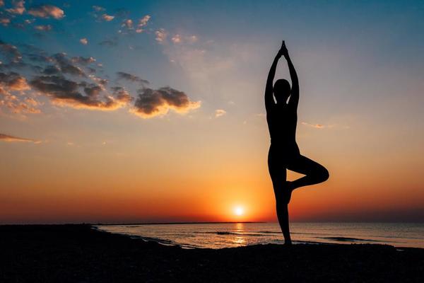 girl on the beach in yoga asana free photo